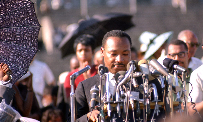 Martin Luther King Jr., Speaking at Rally, Soldier Field, Chicago, 1966 (Umbrellas)