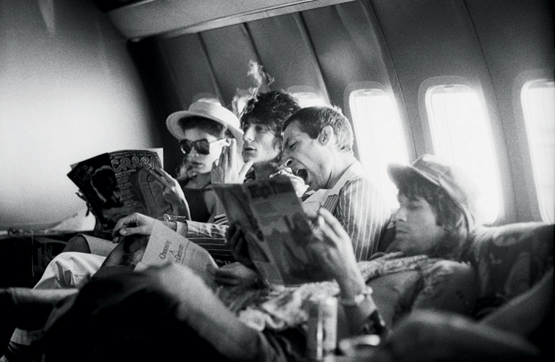 The Rolling Stones Reading Newspapers on Their Plane, 1975