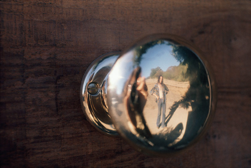 Neil Young Reflection in a Doorknob, Broken Arrow Ranch, CA, 1971