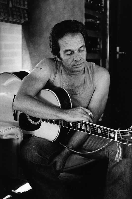 Merle Haggard on his Tourbus with Guitar, 1977