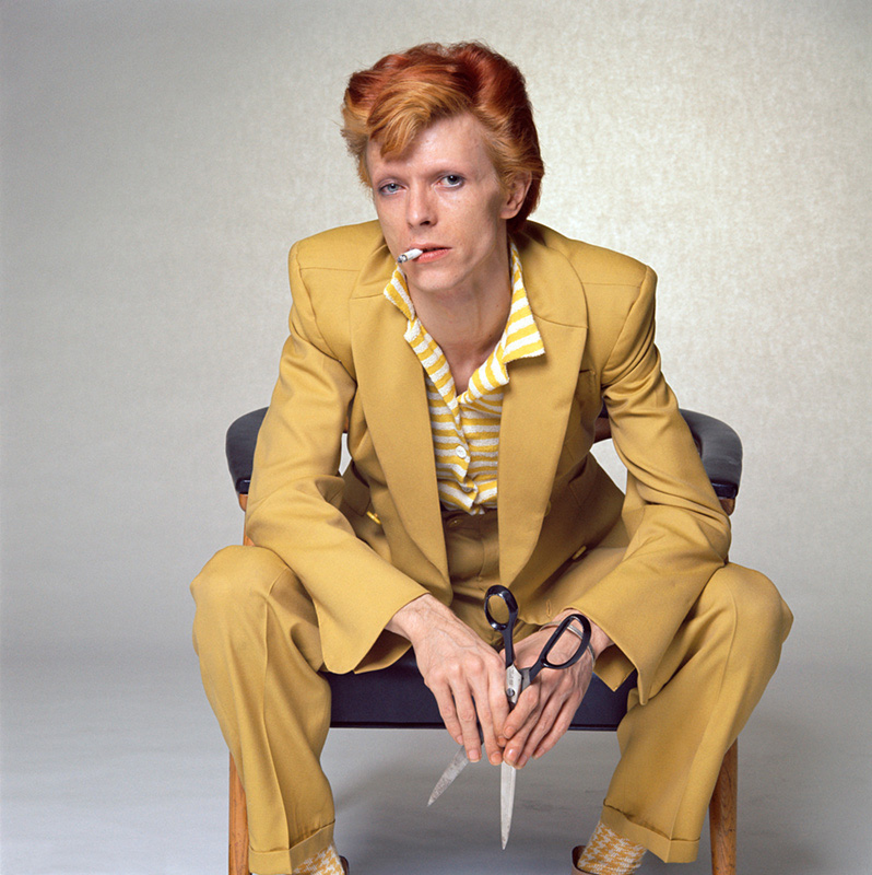 David Bowie, in Mustard Suit Holding Scissors (color), Los Angeles, 1974